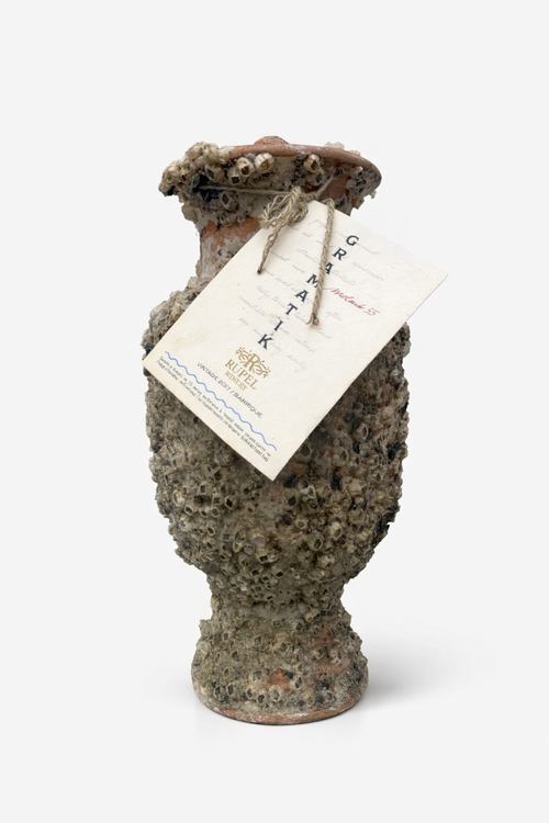 Amphora with a bottle of Gramatik Melnik 55 2017 wine
